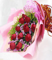A bouquet of 11 red roses with green foliages