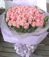 A bouquet of 99 pink roses with green foliages