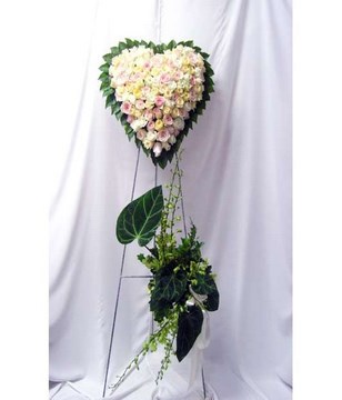 Heart-shaped floral arrangement of pastel roses