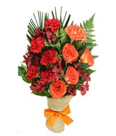 Mix of fresh blooms in reds and oranges