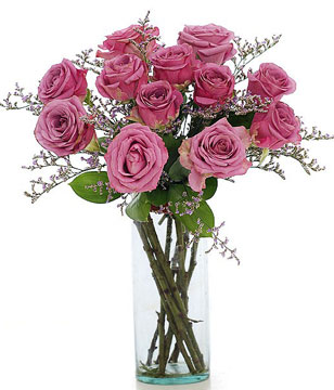 12 Purple roses in a glass vase