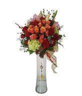 Arrangement of lilies, red roses, cherry brandy rose and many more