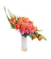 Arrangement of Orange and Pink Carnation with filler in Glass Vase