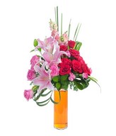 Red rose, pink rose,pink lily, steel grass, pink snap dragon, statice, leaves in glass vase
