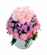 Soft pink roses and pink carnation with purple flower and leave in glass vase