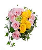 arrangement of pink and yellow roses in heart shape basket