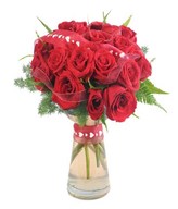 Exquisite floral arrangement in a original vase with vibrant red roses