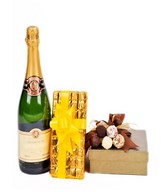 A bottle of champagne with 2 boxes of chocolates