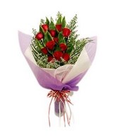12 red roses with cordyline leaves hand bouquet