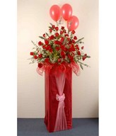 Red Roses, Baby's Breath , Eucalyptus And Balloons On A Red Box Stand 