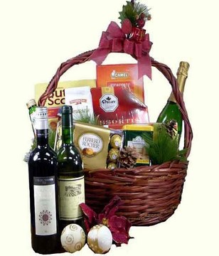 Champagne, 2 bottles of wine with assorted chocolates and titbits in a basket