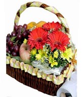 Assorted Fruits With Small Flower Arrangement in a Basket