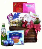 A bottle of sparkling juice with Ferrero Rocher & assorted chocolates in a basket