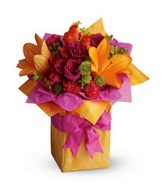 Basket of brightly-colored lilies, purple roses, pink carnations and greeneries