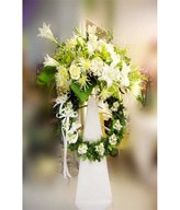 Assorted white flowers on funeral stand